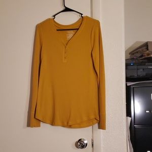 Mustard colored long sleeve waffle shirt.